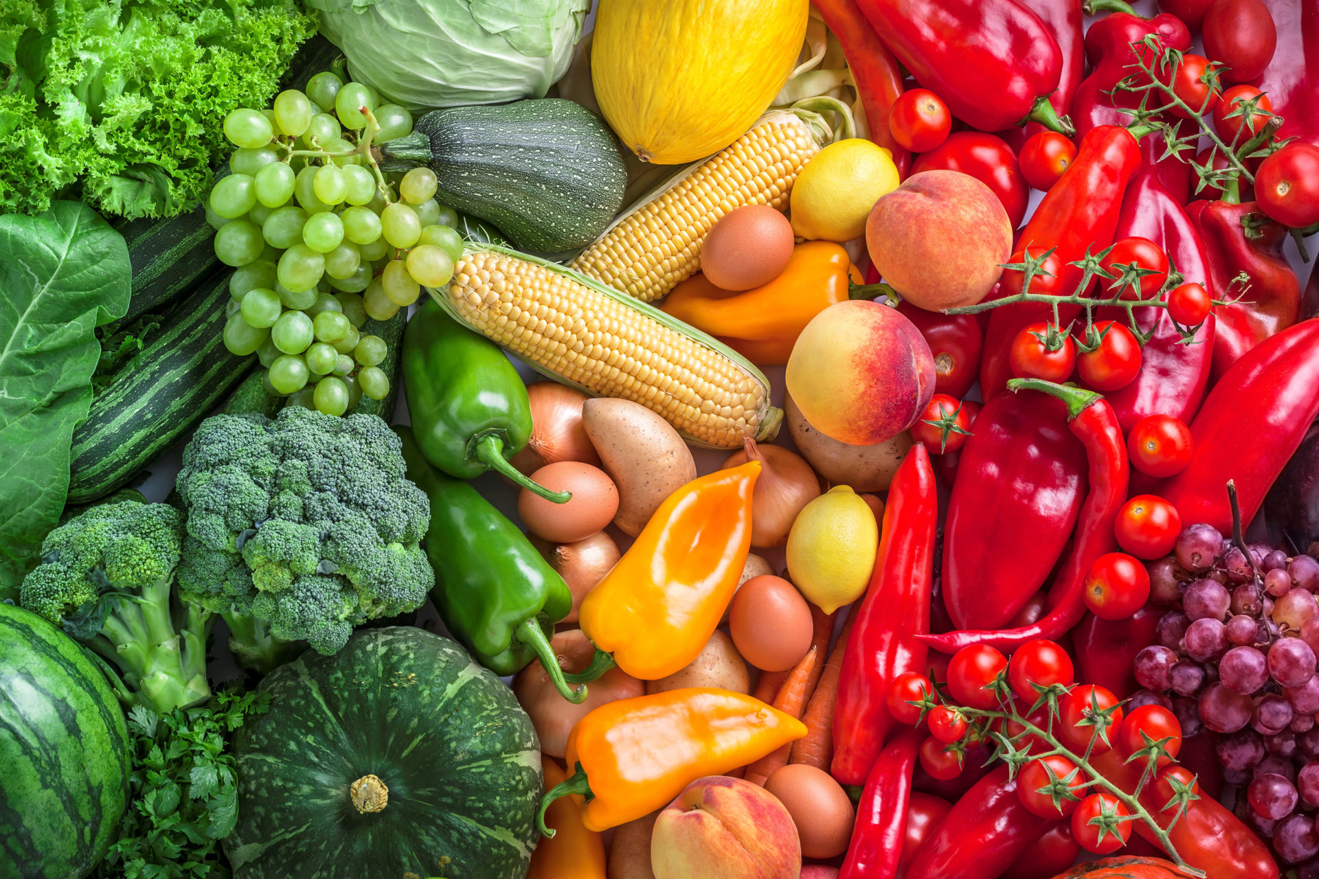 Fruits and vegetables overhead assortment colorful background green, yellow to red